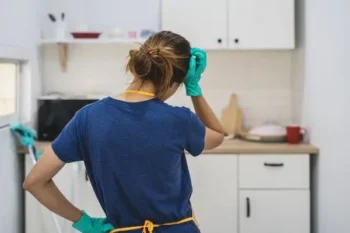 Person with cleaning equipment in a kitchen - Keep rodents away from your property with Russell's Pest Control in Knoxville TN